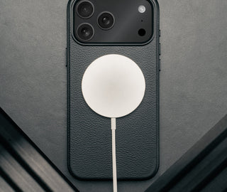 MagSafe charger attached to the Slimline Black Leather Bumper Case for iPhone 17 Pro