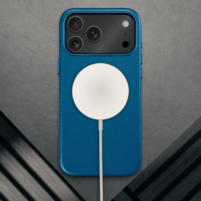 MagSafe charger attached to the Slimline Cobalt Blue Leather Bumper Case for iPhone 17 Pro Max