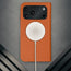 MagSafe charger attached to the Stand function of the Orange Leather Case for iPhone 17 Pro Max