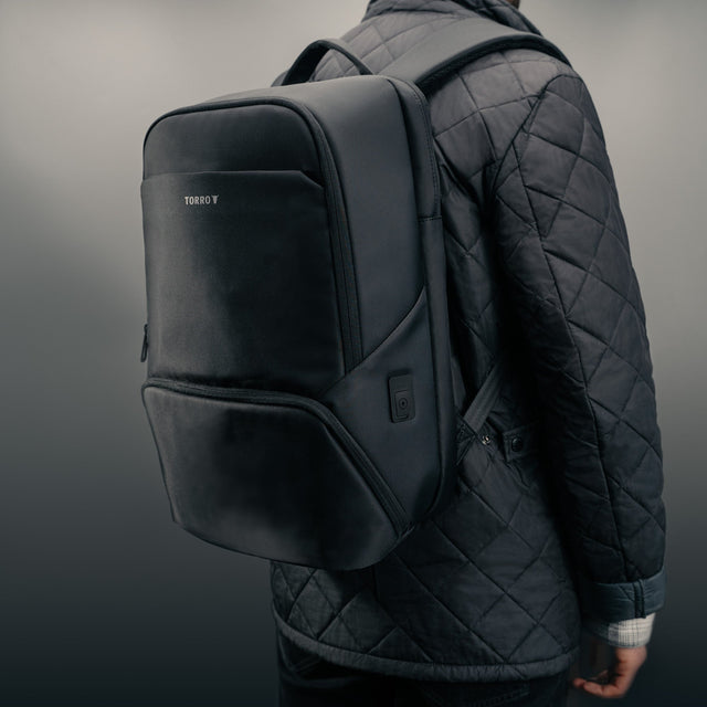 Man carrying the Black Commuter Backpack