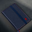 Close up of the TORTO bulls head logo on the front of the Navy Blue Leather (with Red Stitching) Passport holder